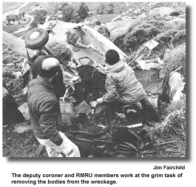 The deputy coroner and RMRU members work at the grim task of removing the bodies from the wreckage. (photo by Jim Fairchild)