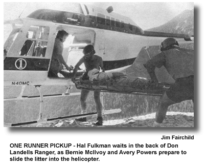 ONE RUNNER PICKUP - Hal Fulkman waits in the back of Don Landells Ranger, as Bernie McIlvoy and Avery Powers prepare to slide the litter into the helicopter. (photo by Jim Fairchild)