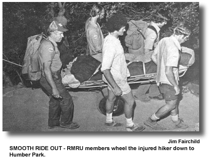SMOOTH RIDE OUT - RMRU members wheel the injured hiker down to Humber Park. (photo by Jim Fairchild)