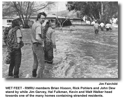 WETFEET - RMRU members Brian Hixson, Rick Pohlers and John Dew stand by while Jim Garvey, Hal Fulkman, Kevin and Walt Walker head towards one of the many homes containing stranded residents. (photo by Jim Fairchild)