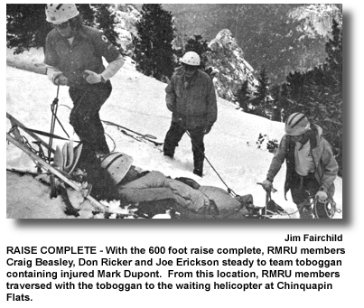 RAISE COMPLETE – With the 600 foot raise complete, RMRU members Craig Beasley, Don Ricker and Joe Erickson steady to team toboggan containing injured Mark Dupont. From this location, RMRU members traversed with the toboggan to the waiting helicopter at Chinquapin Flats. (photo by Jim Fairchild)