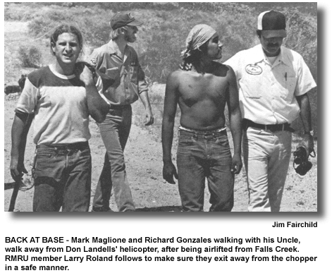 BACK AT BASE - Mark Maglione and Richard Gonzales walking with his Uncle, walk away from Don Landells' helicopter, after being airlifted from Falls Creek. RMRU member Larry Roland follows to make sure they exit away from the chopper in a safe manner. (photo by Jim Fairchild)