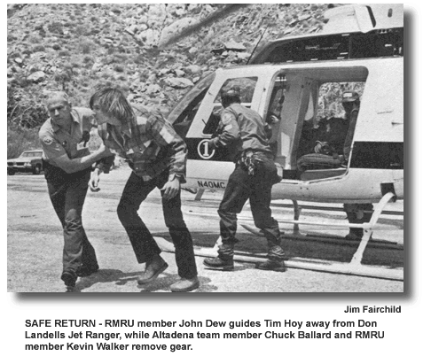 SAFE RETURN – RMRU member John Dew guides Tim Hoy away from Don Landells Jet Ranger, while Altadena team member Chuck Ballard and RMRU member Kevin Walker remove gear. (photo by Jim Fairchild)