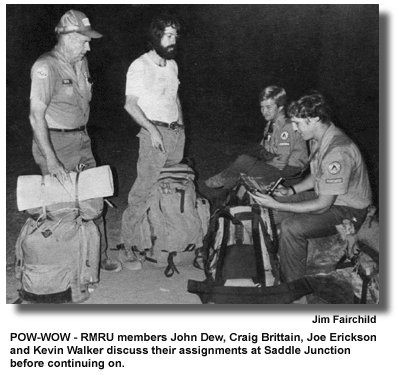 POW-WOW - RMRU members John Dew, Craig Brittain, Joe Erickson and Kevin Walker discuss their assignments at Saddle Junction before continuing on. (photo by Jim Fairchild)