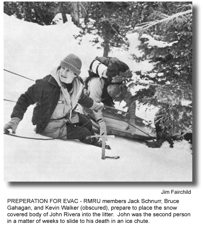 PREPERATION FOR EVAC – RMRU members Jack Schnurr, Bruce Gahagan, and Kevin Walker (obscured), prepare to place the snow covered body of John Rivera into the litter. John was the second person in a matter of weeks to slide to his death in an ice chute. (photo by Jim Fairchild)