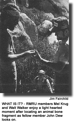 WHAT IS IT? - RMRU members Mel Krug and Walt Walker enjoy a light hearted moment after locating an animal bone fragment as fellow member John Dew looks on. (photo by Jim Fairchild)