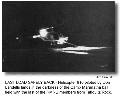 LAST LOAD SAFELY BACK - Helicopter 816 piloted by Don Landells lands in the darkness of the Camp Maranatha ball field with the last of the RMRU members from Tahquitz Rock. (photo by Jim Fairchild)