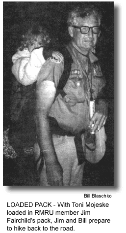 LOADED PACK - With Toni Mojeske loaded in RMRU member Jim Fairchild's pack, Jim and Bill prepare to hike back to the road. (photo by Bill Blaschko)