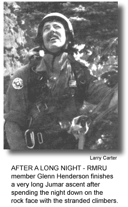 AFTER A LONG NIGHT - RMRU member Glenn Henderson finishes a very long Jumar ascent after spending the night down on the rock face with the stranded climbers. (phot by Larry Carter)