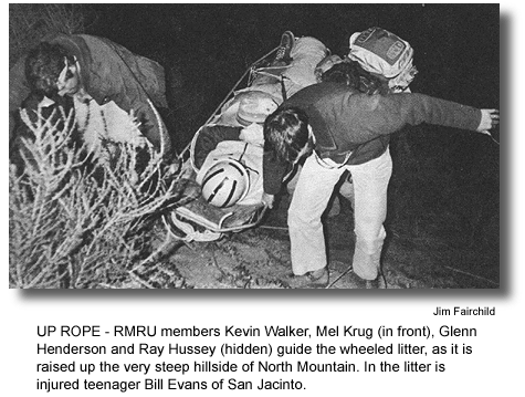 UP ROPE - RMRU members Kevin Walker, Mel Krug (in front), Glenn Henderson and Ray Hussey (hidden) guide the wheeled litter, as it is raised up the very steep hillside of North Mountain. In the litter is injured teenager Bill Evans of San Jacinto. (photo by Jim Fairchild)