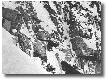 Members unloading gear from the bird. From one side of the ledge there was a drop of 100 feet to the main chute, and on the other side it was better than 300 feet to the bottom.