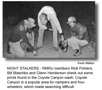 NIGHT STALKERS - RMRU members Rick Pohlers, Bill Blaschko and Glenn Henderson check out some prints found in the Coyote Canyon wash. Coyote Canyon is a popular area for campers and four-wheelers, which made searching difficult. (photo by Kevin Walker)