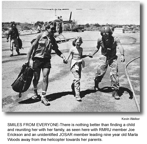 SMILES FROM EVERYONE-There is nothing better than finding a child and reuniting her with her family, as seen here with RMRU member Joe Erickson and an unidentified JOSAR member leading nine year old Marla Woods away from the helicopter towards her parents. (photo by Kevin Walker)