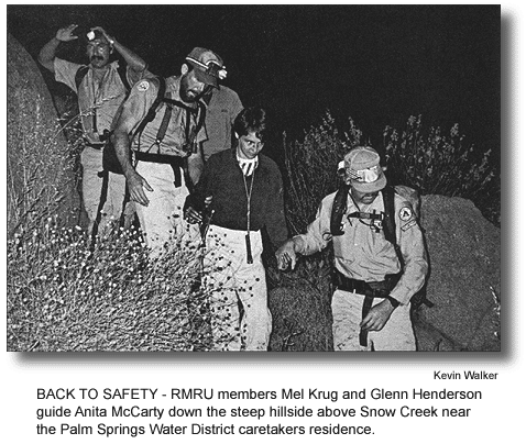 BACK TO SAFETY - RMRU members Mel Krug and Glenn Henderson guide Anita McCarty down the steep hillside above Snow Creek near the Palm Springs Water District caretakers residence. (photo by Kevin Walker)