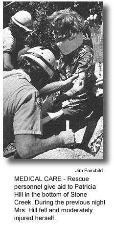 MEDICAL CARE - Rescue personnel give aid to Patricia Hill in the bottom of Stone Creek. During the previous night Mrs. Hill fell and moderately injured herself. (photo by Jim Fairchild)