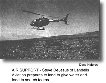 AIR SUPPORT - Steve DeJesus of Landell's Aviation prepares to land to give water and food to search teams. (photo by Dona Halcrow)