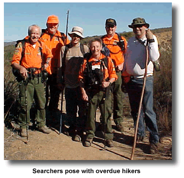 Searchers pose with overdue hikers