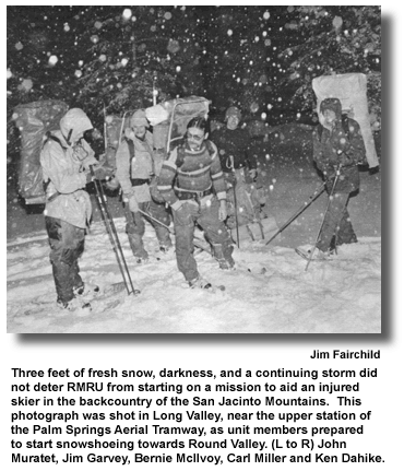 Three feet of fresh snow, darkness, and a continuing storm did not deter RMRU from starting on a mission to aid an injured skier in the backcountry of the San Jacinto Mountains.  This photograph was shot in Long Valley, near the upper station of the Palm Springs Aerial Tramway, as unit members prepared to start snowshoeing towards Round Valley. (L to R) John Muratet, Jim Garvey, Bernie McIlvoy, Carl Miller and Ken Dahike. (photo by Jim Fairchild)
