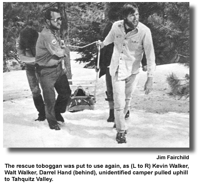 The rescue toboggan was put to use again, as (L to R) Kevin Walker, Walt Walker, Darrel Hand (behind), unidentified camper pulled uphill to Tahquitz Valley. (photo by Jim Fairchild)