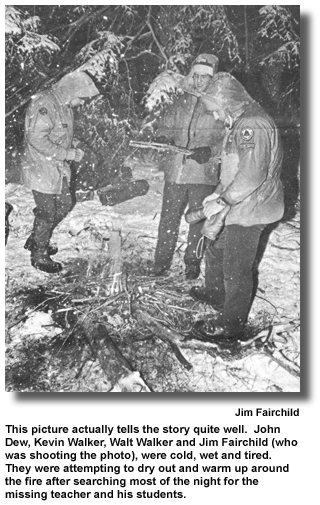 This picture actually tells the story quite well. John Dew, Kevin Walker, Walt Walker and Jim Fairchild (who was shooting the photo), were cold, wet and tired. They were attempting to dry out and warm up around the fire after searching most of the night for the missing teacher and his students. (photo by Jim Fairchild)