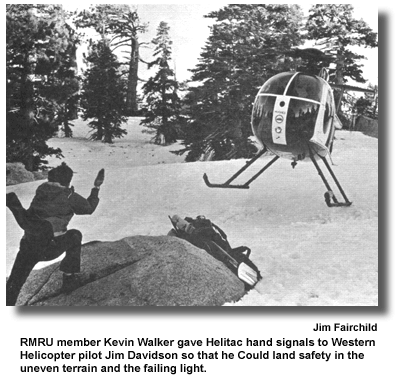 RMRU member Kevin Walker gave Helitac hand signals to Western Helicopter pilot Jim Davidson so that he Could land safety in the uneven terrain and the failing light. (photo by Jim Fairchild)