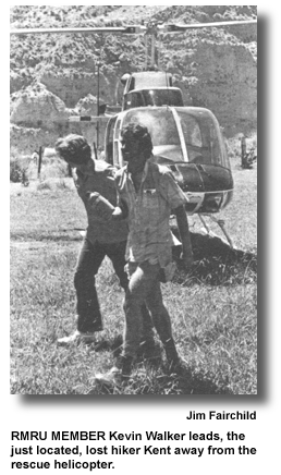 RMRU MEMBER Kevin Walker leads, the just located, lost hiker Kent away from the rescue helicopter. (photo by Jim Fairchild)