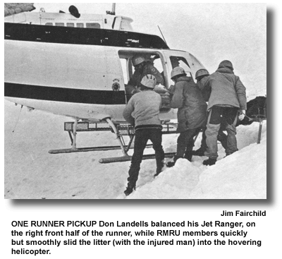 ONE RUNNER PICKUP Don Landells balanced his Jet Ranger, on the right front half of the runner, while RMRU members quickly but smoothly slid the litter (with the injured man) into the hovering helicopter. (photo by Jim Fairchild)