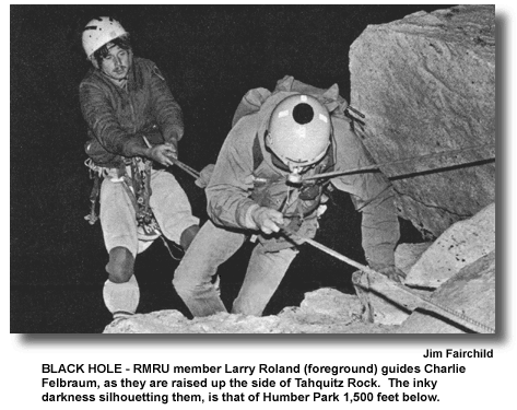 BLACK HOLE – RMRU member Larry Roland (foreground) guides Charlie Felbraum, as they are raised up the side of Tahquitz Rock. The inky darkness silhouetting them, is that of Humber Park 1,500 feet below. (photo by Jim Fairchild)