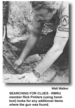 SEARCHING FOR CLUES - RMRU member Rick Pohlers (using hand-tool) looks for any additional items where the gun was found. (photo by Walt Walker)