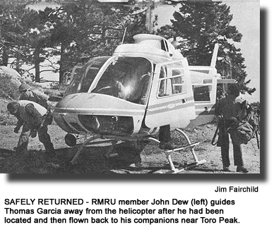 SAFELY RETURNED - RMRU member John Dew (left) guides Thomas Garcia away from the helicopter after he had been located and then flown back to his companions near Toro Peak. (photo by Jim Fairchild)