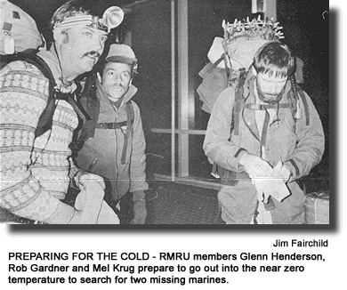 PREPARING FOR THE COLD - RMRU members Glenn Henderson, Rob Gardner and Mel Krug prepare to go out into the near zero temperature to search for two missing marines. (photo by Jim Fairchild)