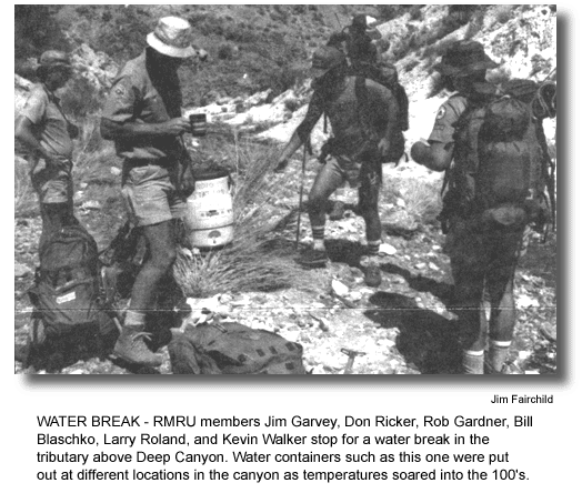 WATER BREAK - RMRU members Jim Garvey, Don Ricker, Rob Gardner, Bill Blaschko, Larry Roland, and Kevin Walker stop for a water break in the tributary above Deep Canyon. Water containers such as this one were put out at different locations in the canyon as temperatures soared into the 100's. (photo by Jim Fairchild)