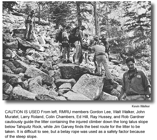 CAUTION IS USED From left, RMRU members Gordon Lee, Walt Walker, John Muratet, Larry Roland, Colin Chambers, Ed Hill, Ray Hussey, and Rob Gardner cautiously guide the litter containing the injured climber down the long talus slope below Tahquitz Rock, while Jim Garvey finds the best route for the litter to be taken. It is difficult to see, but a belay rope was used as a safety factor because of the steep slope. (photo by Kevin Walker)