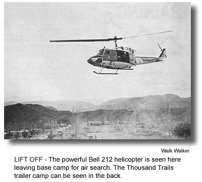 LIFT OFF - The powerful Bell 212 helicopter is seen here leaving base camp for air search. The Thousand Trails trailer camp can be seen in the back. (photo by Walk Walker)