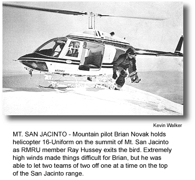 MT. SAN JACINTO - Mountain pilot Brian Novak holds helicopter 16-Uniform on the summit of Mt. San Jacinto as RMRU member Ray Hussey exits the bird. Extremely high winds made things difficult for Brian, but he was able to let two teams of two off one at a time on the top of the San Jacinto range. (photo by Kevin Walker)
