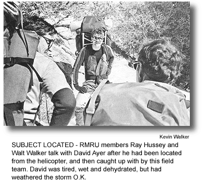 SUBJECT LOCATED - RMRU members Ray Hussey and Walt Walker talk with David Ayer after he had been located from the helicopter, and then caught up with by this field team. David was tired, wet and dehydrated, but had weathered the storm O.K. (photo by Kevin Walker)